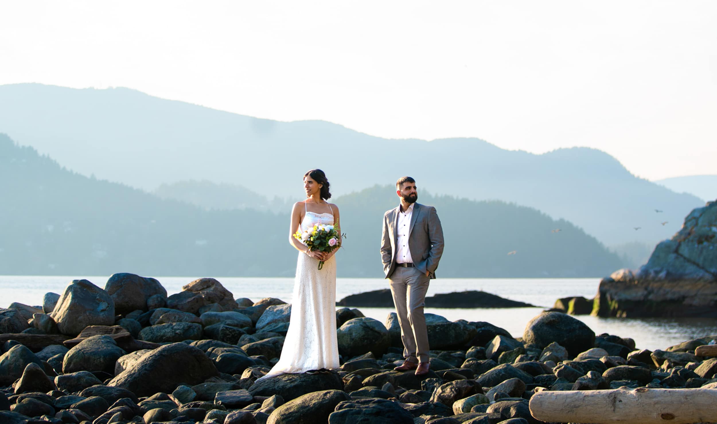 Bride and groom portraits on lake with mountains in background - Vancouver Elopement Photography